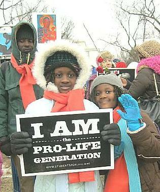 Two little girls with sign that says, 
'I Am the Pro-Life Generation'