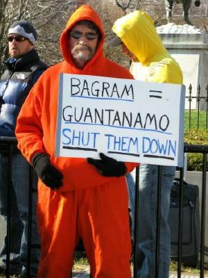 Man dressed in orange prisoner's uniform protests U.S. torture