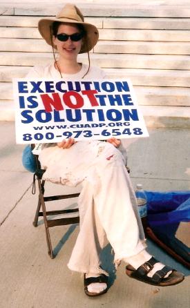 Woman holds sign that says, 'Execution is Not 
the Solution'